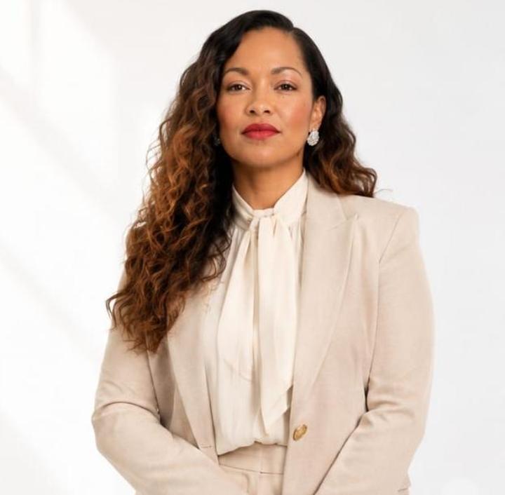 Portrait of Apostle Dr. Shanon Adams in a light suit, Founder of N.A.K.E.D & Unashamed